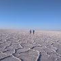 Hikers crossing a salt lake